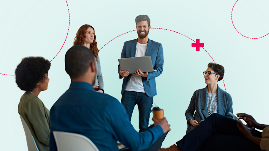 male and female work professionals sitting and standing in a circle chatting in a office