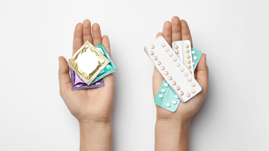 left-hand-holding-condoms-right-hand-holding-birth-control-pills