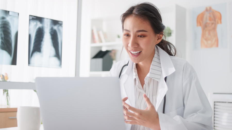 Doctor in her office or surgery speaking to a patient via a computer in a telehealth consultation.