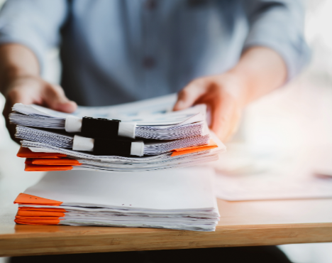 A man picking up large files 