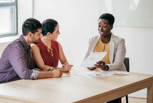 Family lawyer speaking to a client couple.