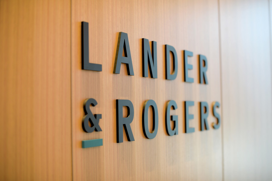 Lander & Rogers lettering on timber wall