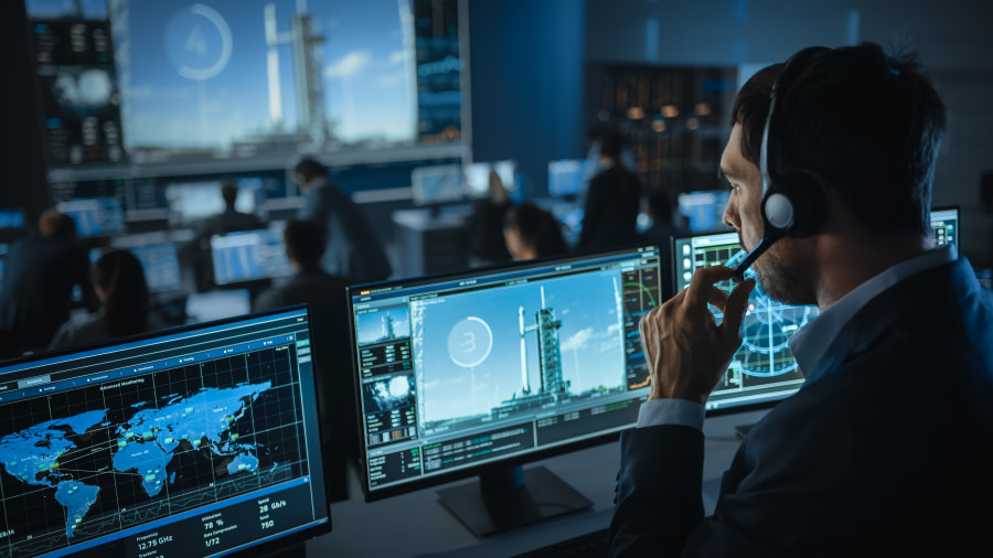 Space launch operator working at a computer.