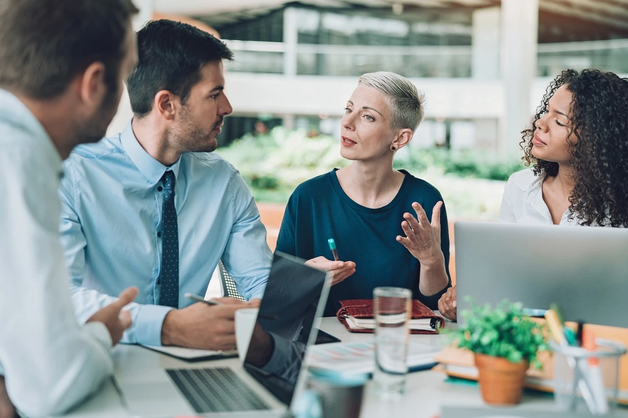 Colleagues talking in a meeting.