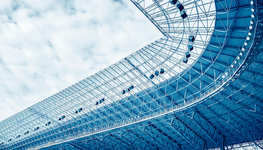 A sports arena or stadium roof pictured from below. 