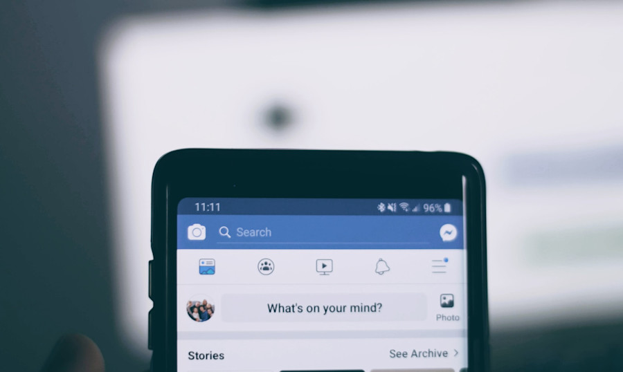 A mobile device showing the homepage of a Facebook profile.