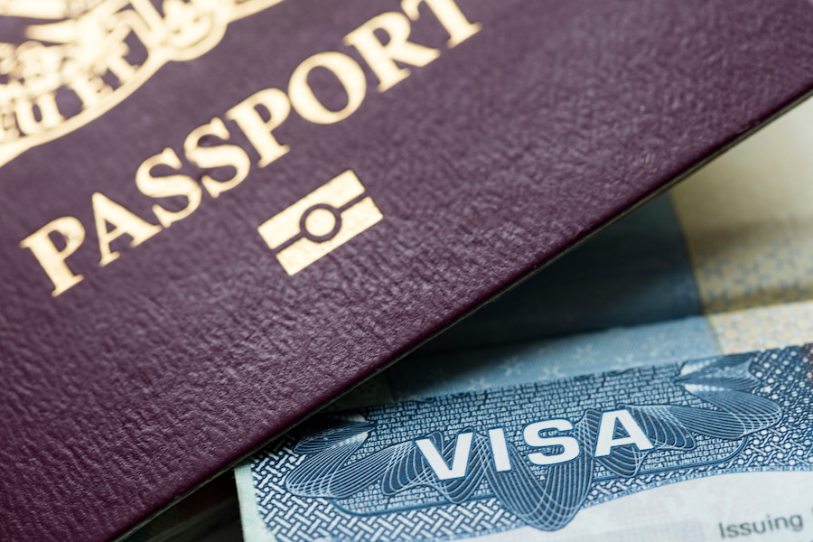 Close-up of a passport and a visa document.