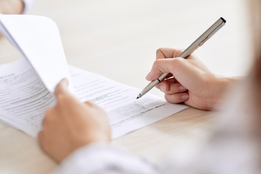 Photo of woman signing contract