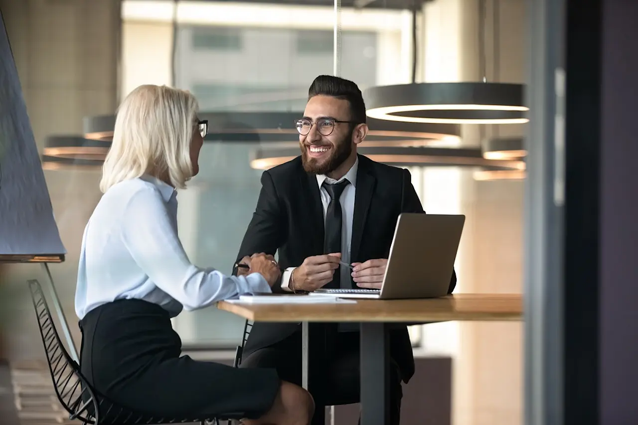 Two people talking in a meeting.