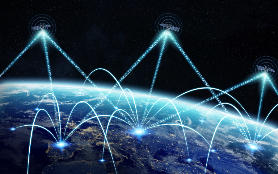 Global network and satellite data exchange pictured against the Earth at night.