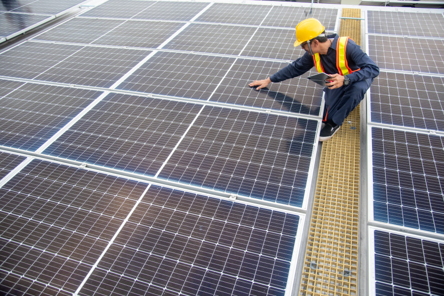 industrial rooftop with multiple solar panels on it