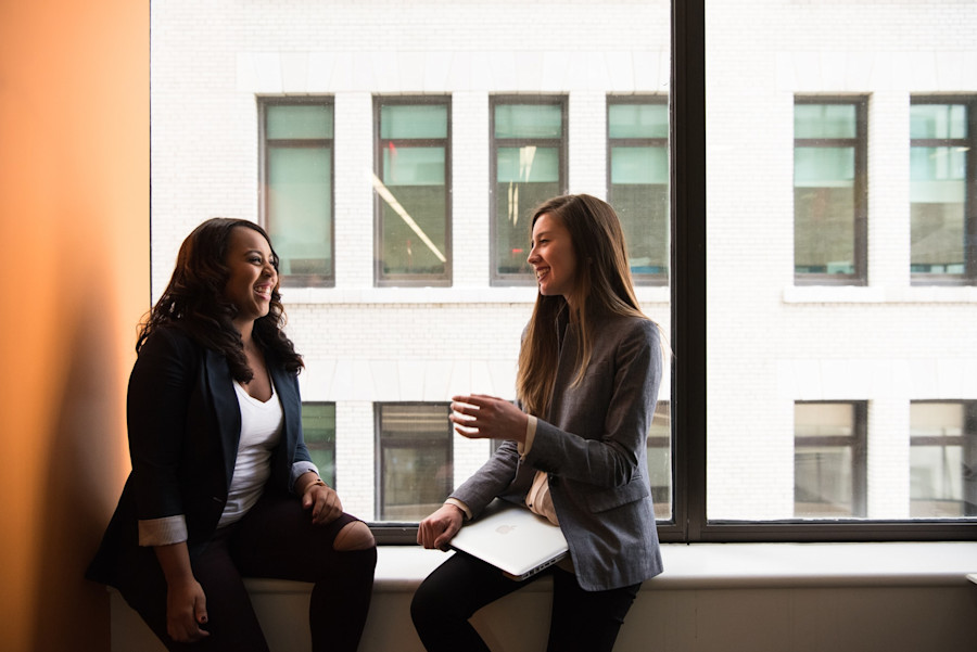 Two women having a conversation as colleagues.