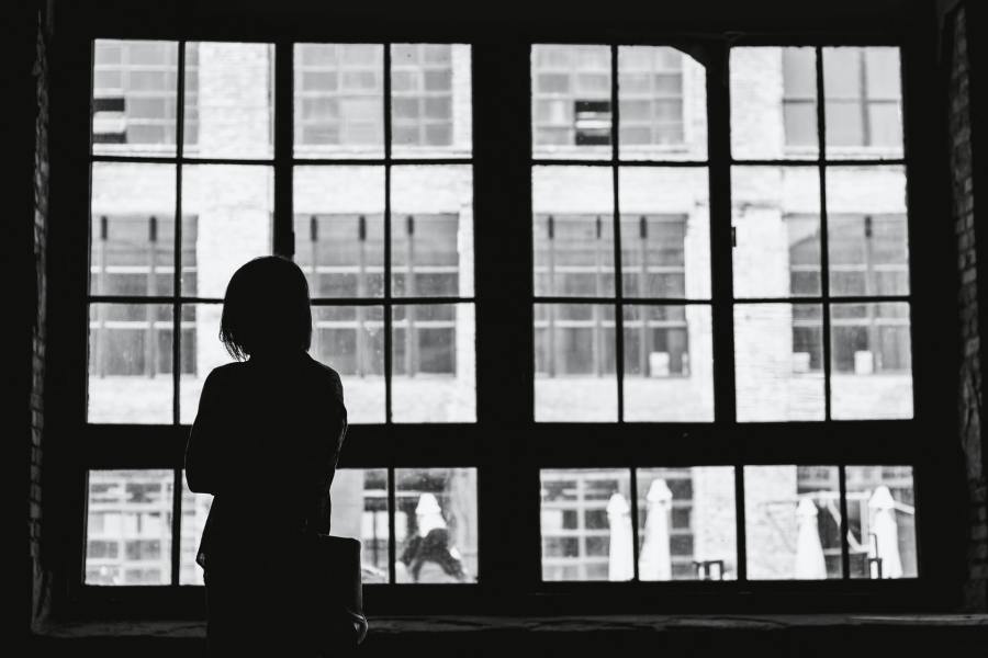 Woman standing in front of a window.
