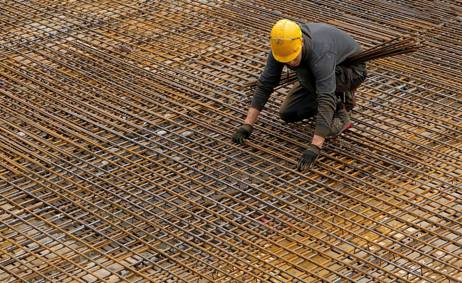 A worker on a building site in a hard hat.