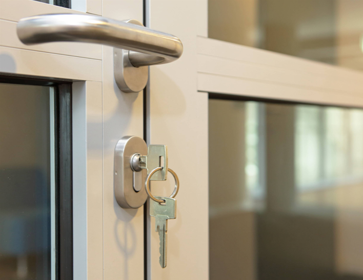 close-up of a key in the lock of a commercial property door, symbolising tenant administration, business insolvency, leased premises, and the challenges faced by landlords and property owners when a tenant enters voluntary administration.