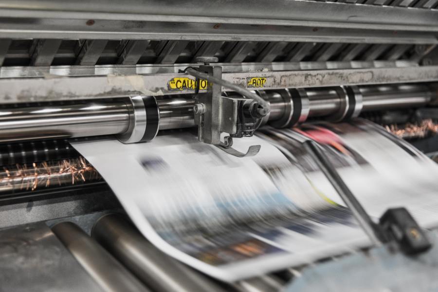 Commercial printer in process of printing a document or publication.