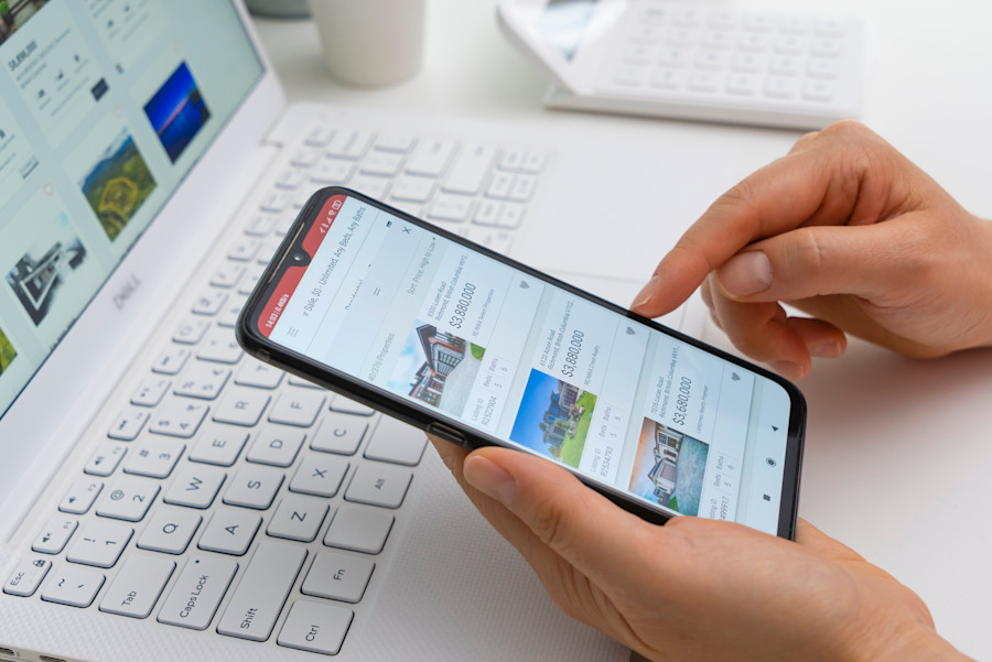 Person searching property listings on their mobile phone.