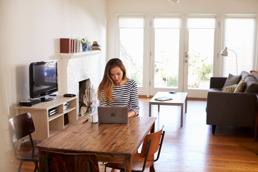 Female working on laptop in home environment