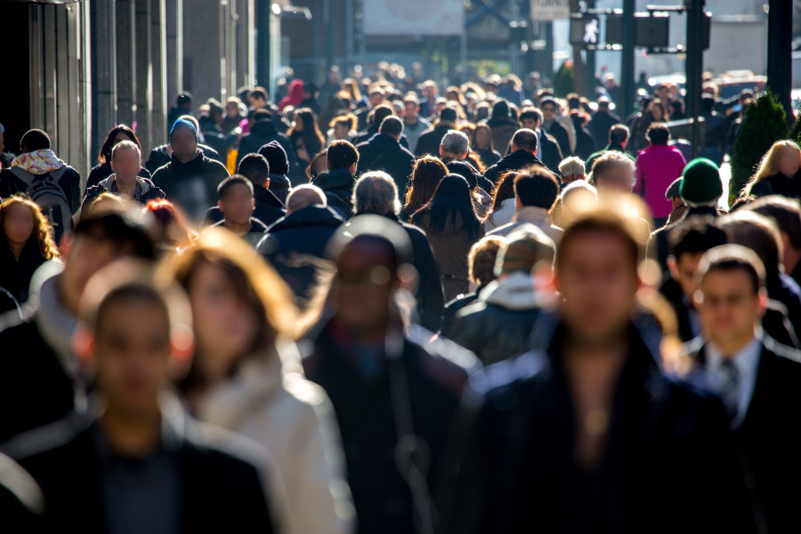 Crowd shot of people walking in a city.