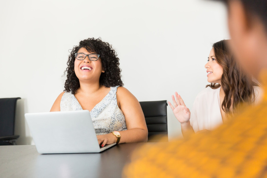 Co-workers in an office spending time together and laughing.