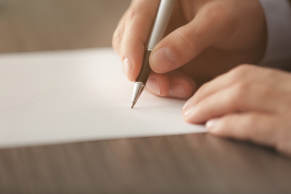 Person signing a document.