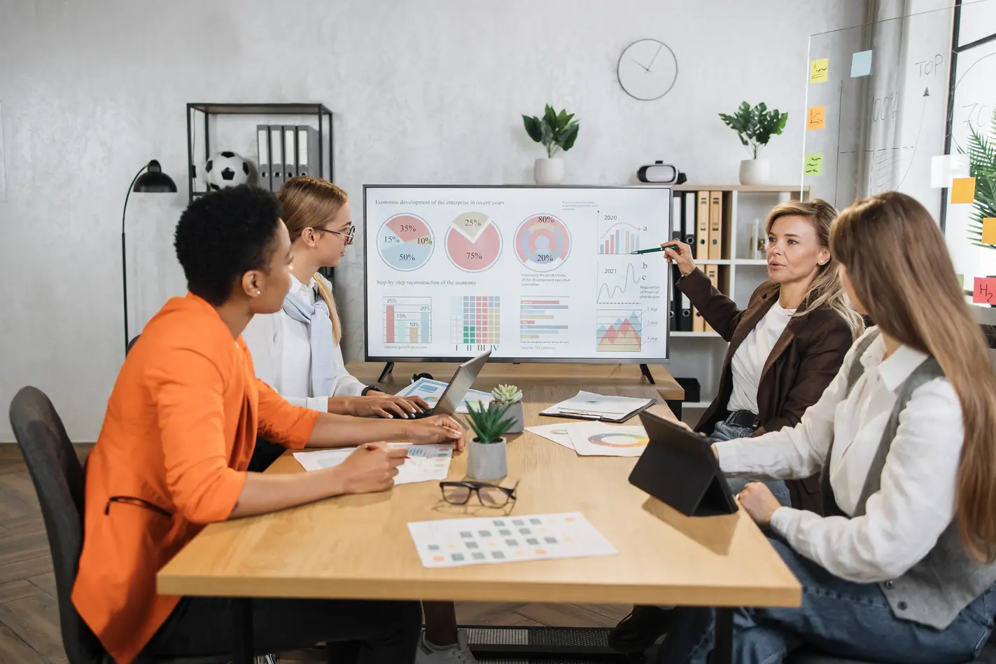 four-female-partners-sitting-at-desk-and-discussin-2023-11-27-05-34-29-utc (1)