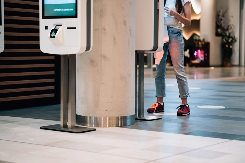 female-using-a-cashless-payment-kiosk