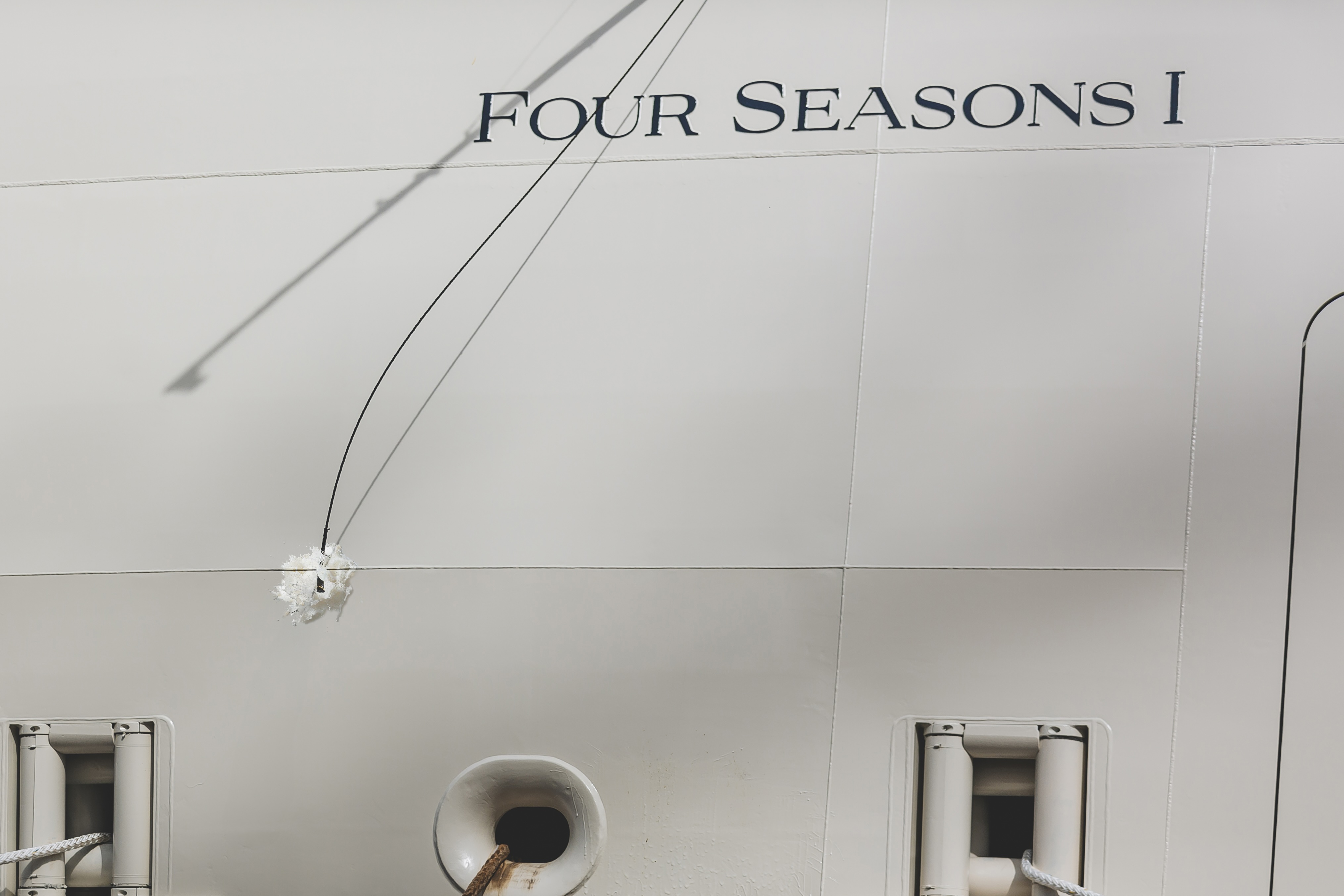 A celebratory moment as the champagne bottle gracefully shatters against the yacht.







