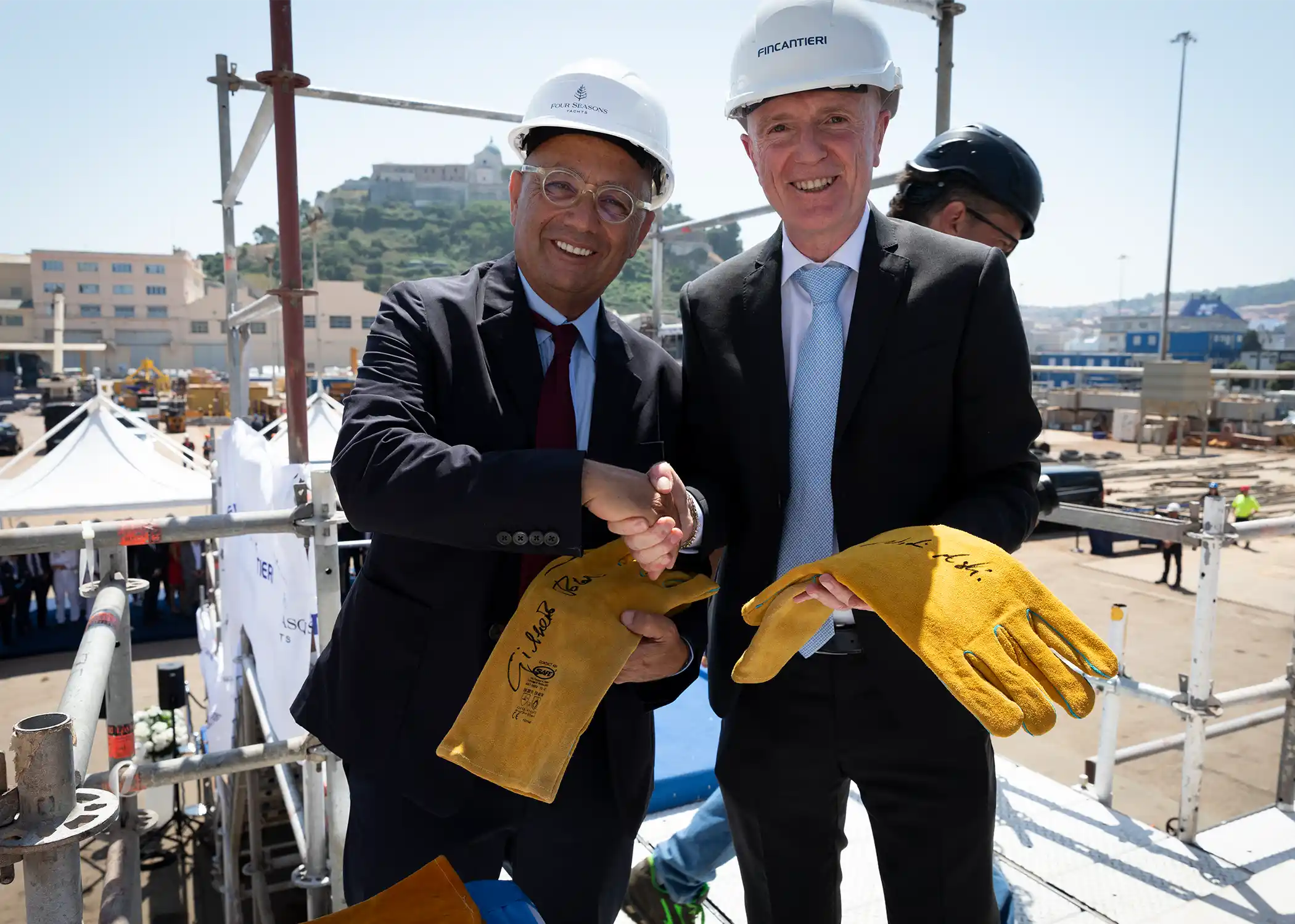 Nadim Ashi and Gilberto Tobaldi, Fincantieri Shipyard Director, with the signed welding gloves.