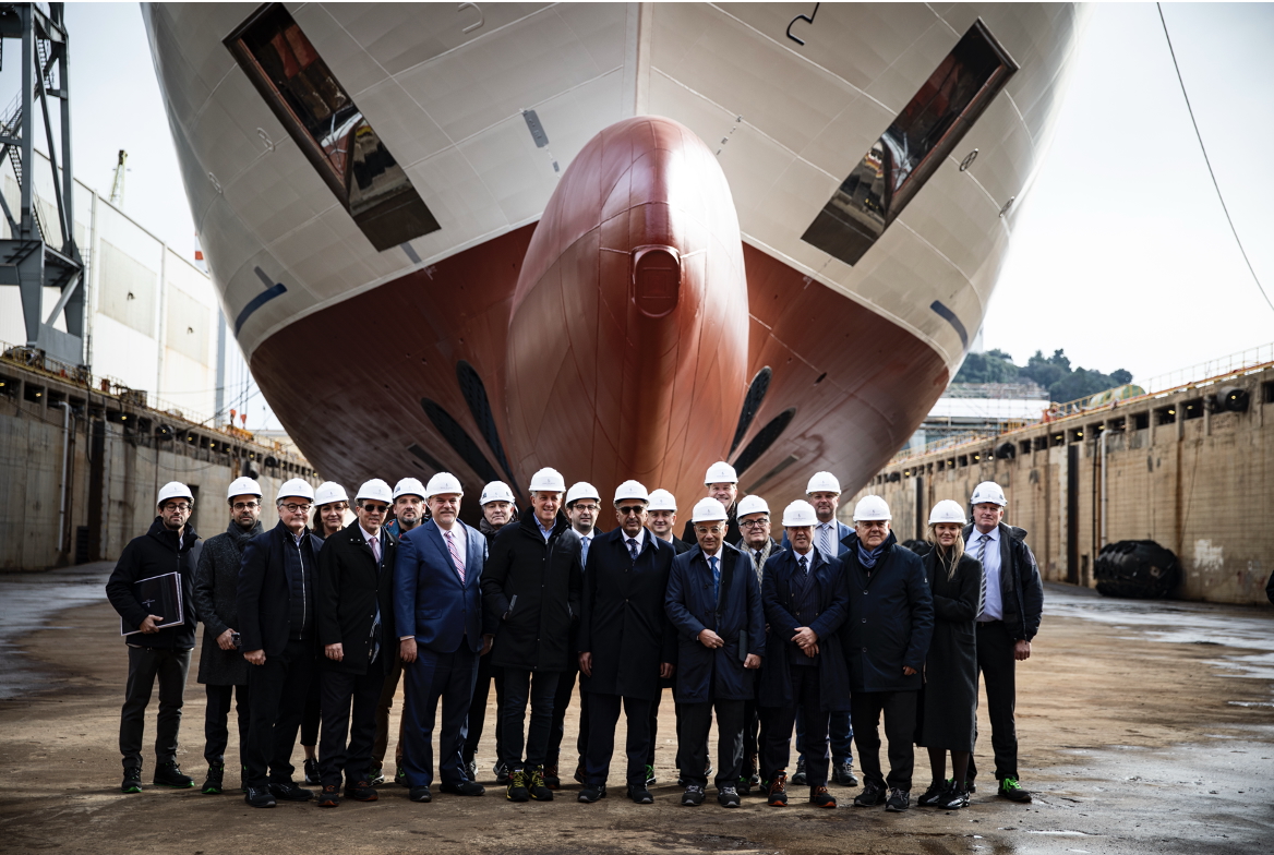 Four Seasons Yachts executive team at hull of plane.