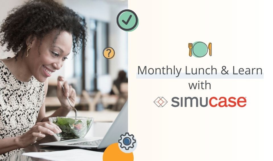 Woman eating a salad by an open laptop computer