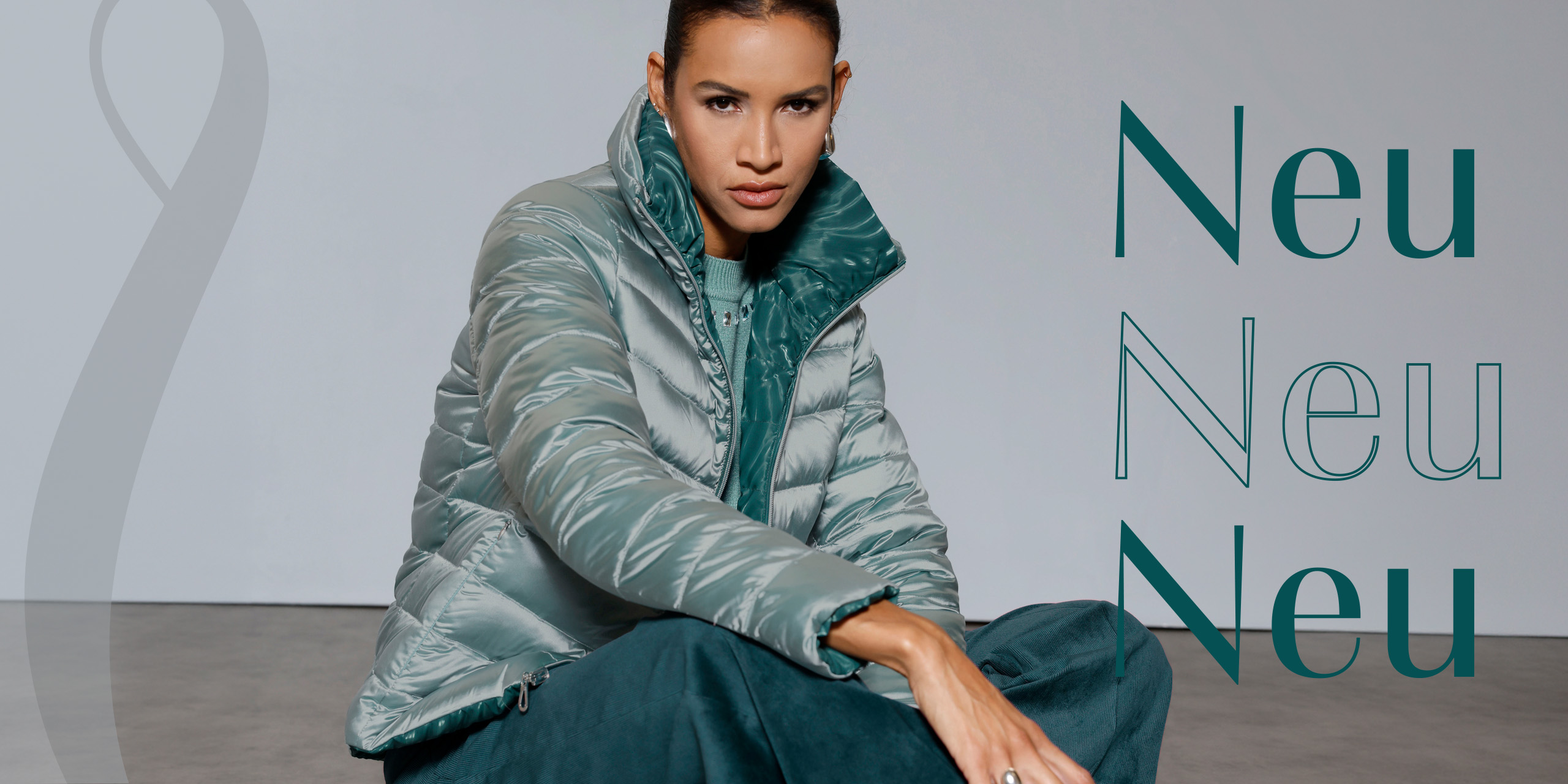 Ein Model sitzt auf dem Boden und trägt eine glänzende, silberne Steppjacke mit grünem Innenfutter. Rechts steht mehrfach das Wort 'Neu'.