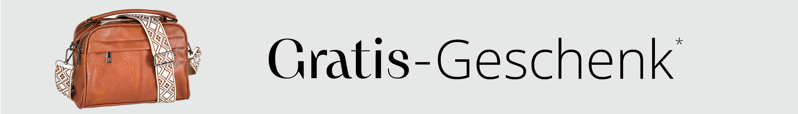 Eine braune Umhängetasche mit gemustertem Schulterriemen, daneben steht der Text 'Gratis Geschenk'.