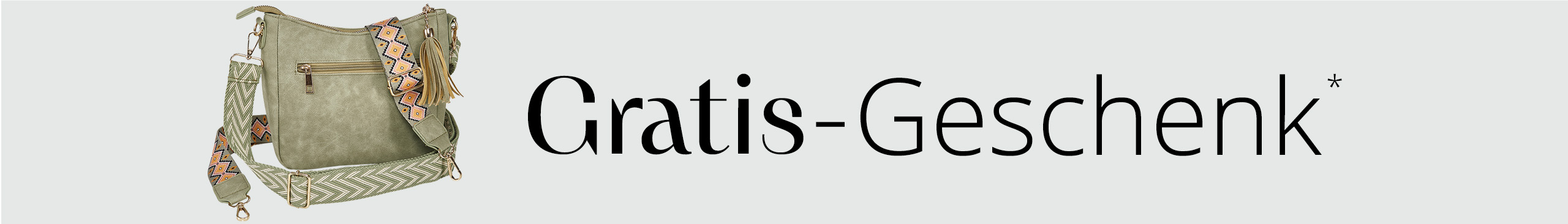 Das Bild zeigt eine grüne Umhängetasche mit gemusterten Trageriemen und einer Quaste. Dneben steht in schwarzer Schrift "Gratis Geschenk*".