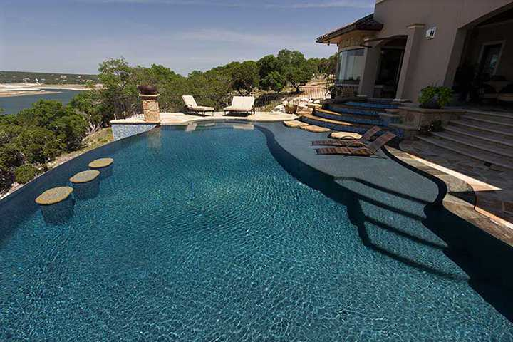 A large swimming pool with stairs leading up to it