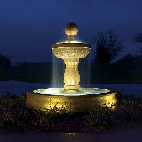 A fountain that is lit up at night