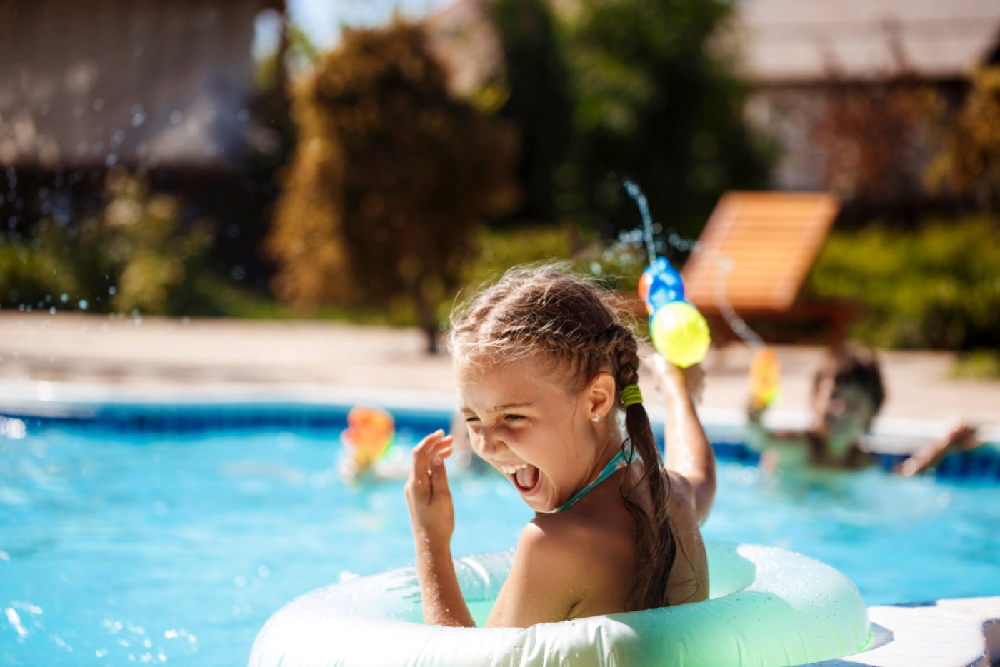 girl playing in swimming pool