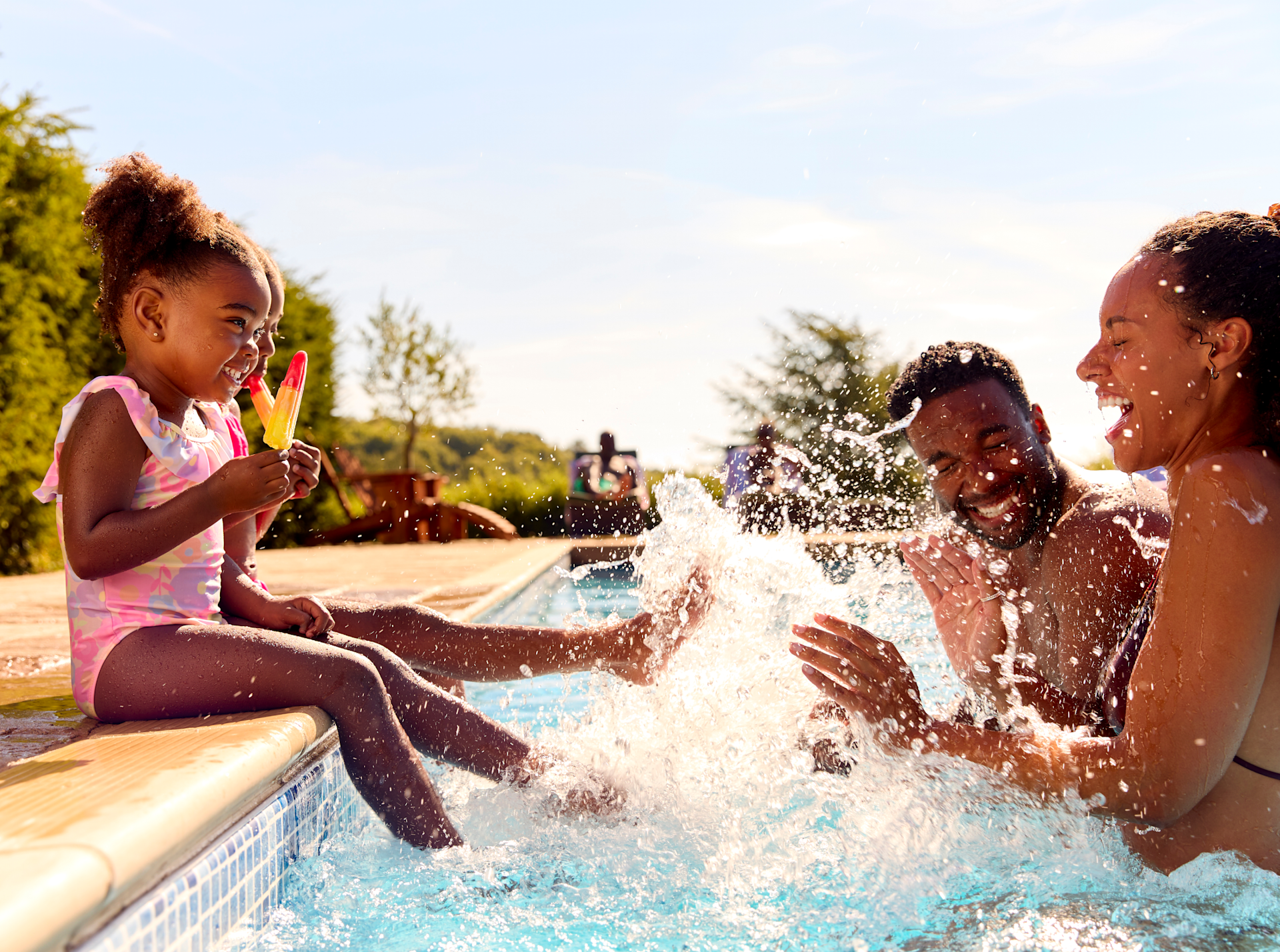 Girls Kicking feet and Splashing Parents