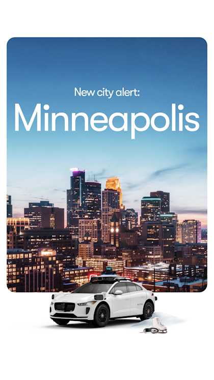 A white, Waymo I-PACE in front of the the Minneapolis skyline