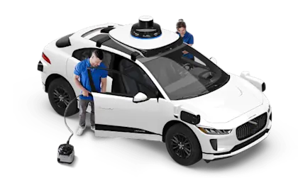 Team cleaning Waymo vehicle