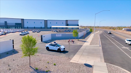 Waymo vehicle driving out of the factory's parking lot