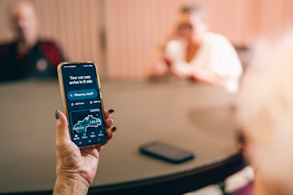 Hailing a Waymo autonomous vehicle at Fairfax Senior Center.