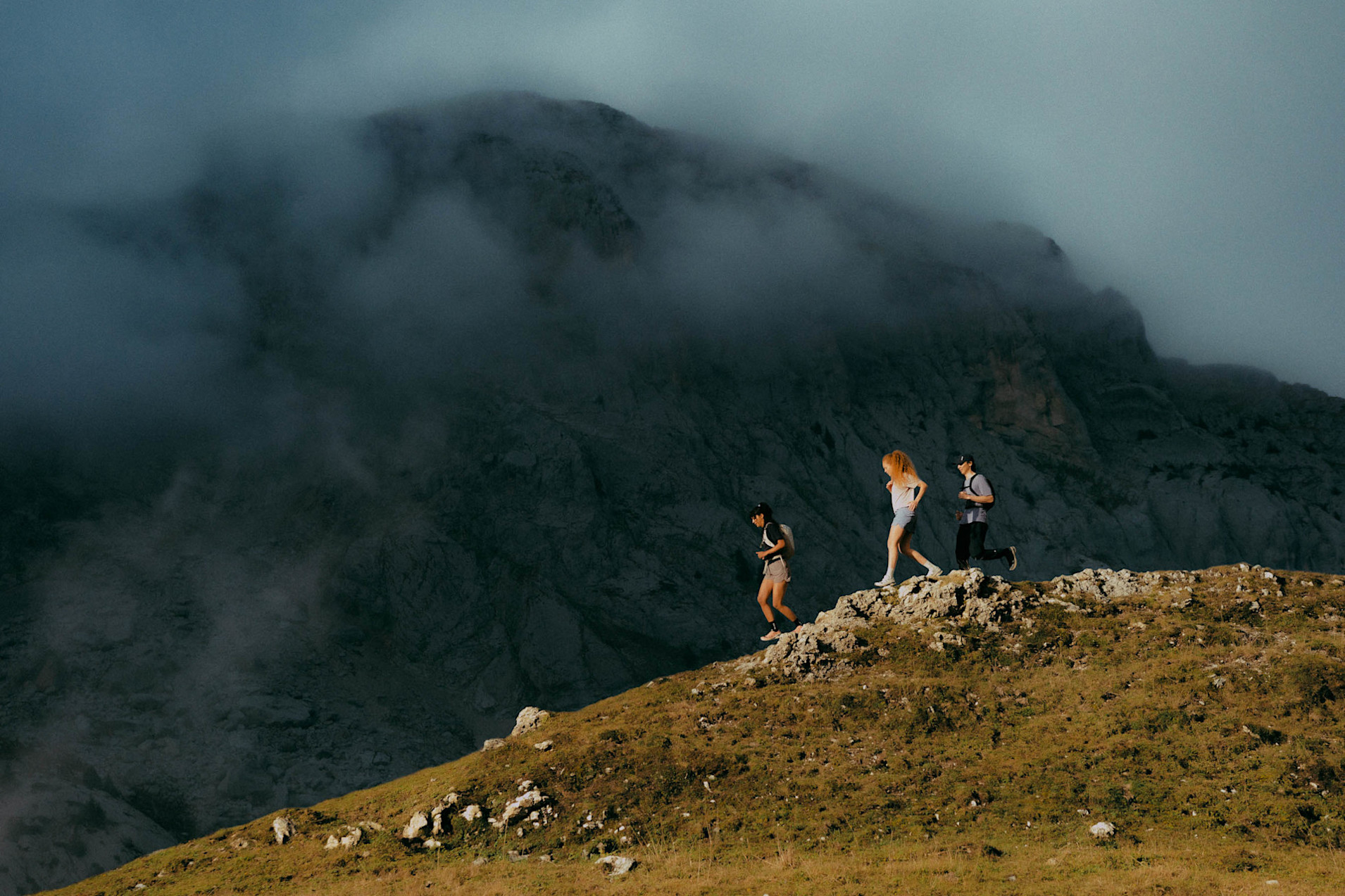 Three trail runners in the mountains