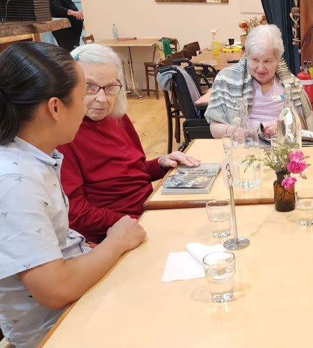 Raj with aged care home residents at a local cat cafe in South Australia