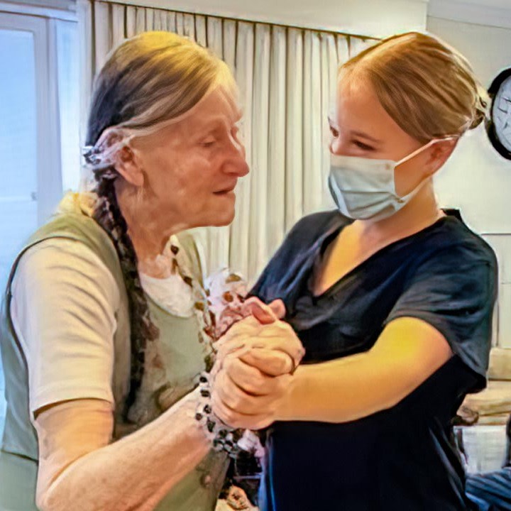 Resident dancing with staff member