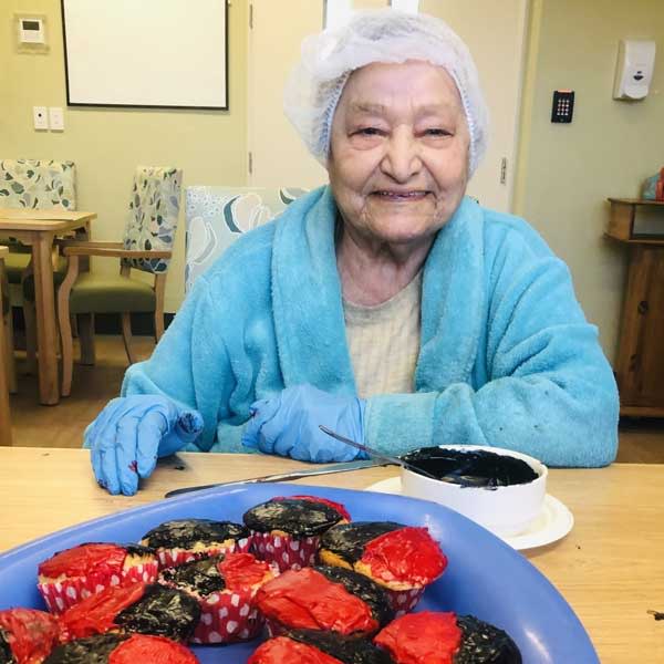 Bupa Greenacre resident Alees making cupcakes for NAIDOC week