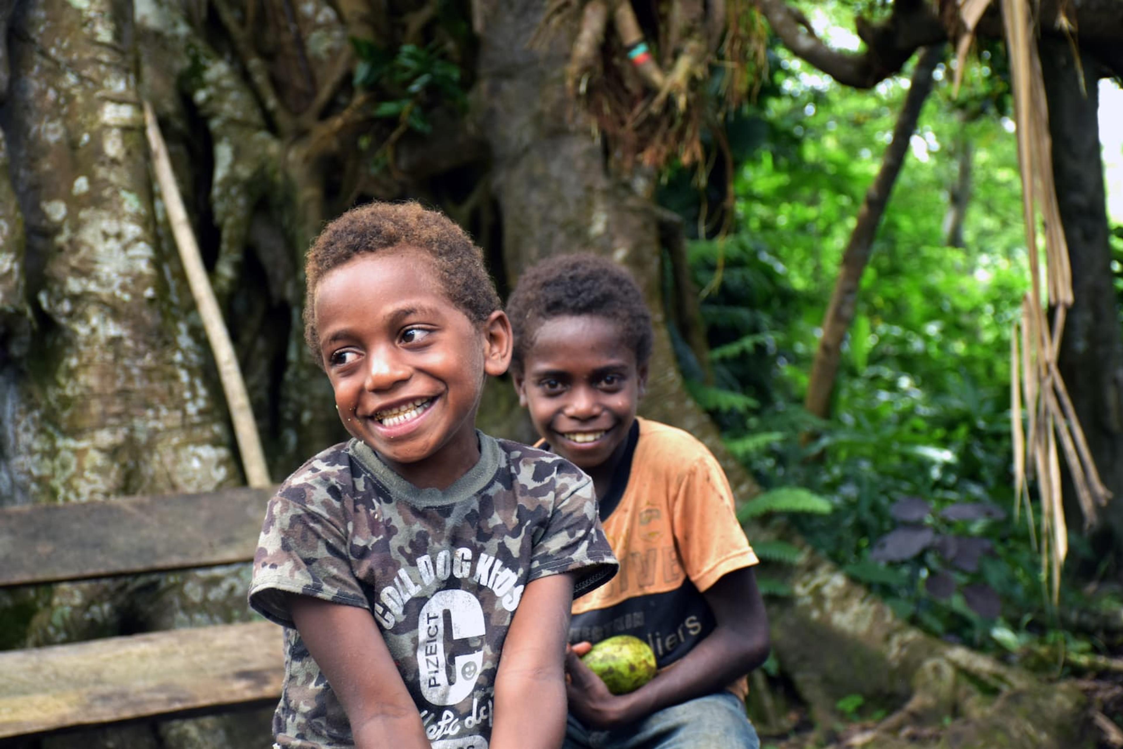 Mark and a friend pose for a photo in the nakamal in Vanuatu