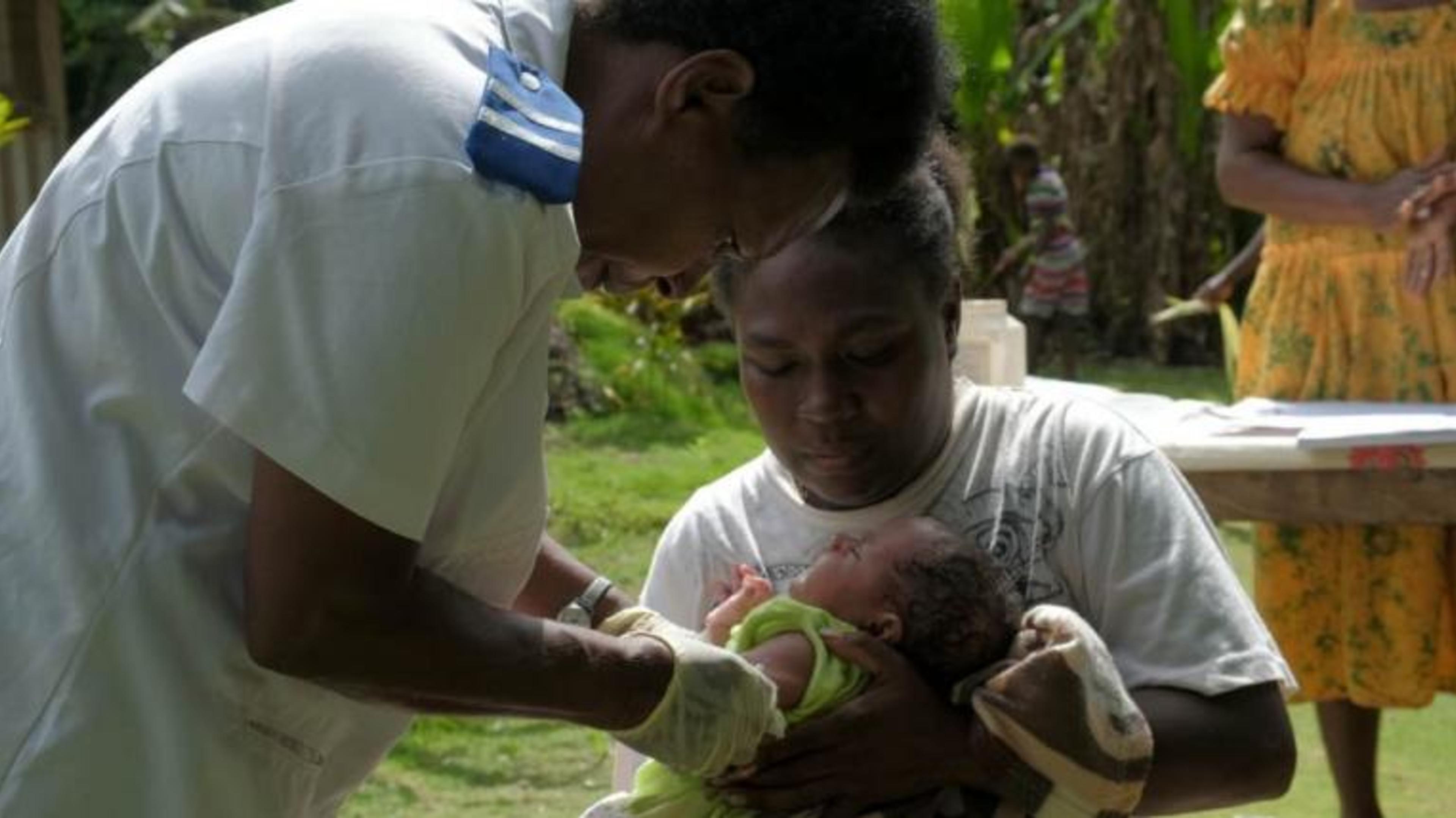 Registered nurse, Miriam Nampil, administers the first vaccine delivery in Cooks Bay, Vanuatu. 