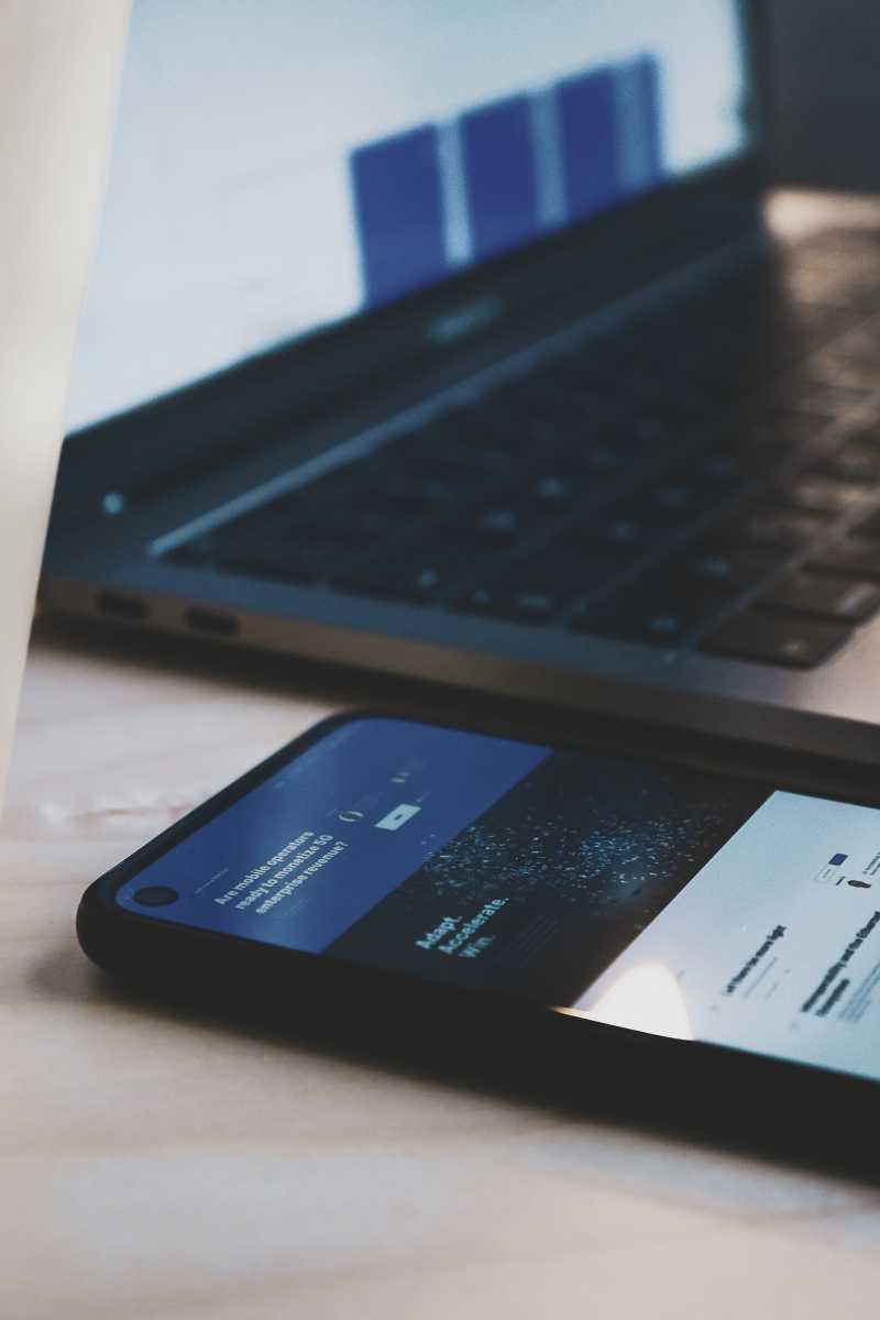 An close up image of a smartphone and laptop keyboard 