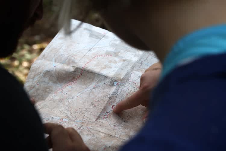 Image of people holding a map and pointing 